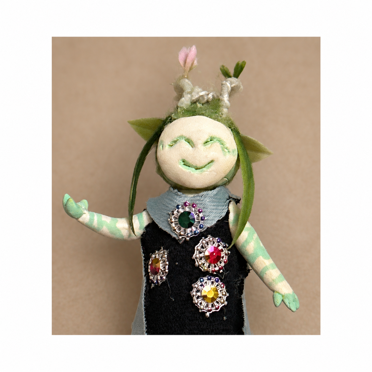 Flora, Bingo’s handmade clay character, shown from the front in a black jeweled outfit.