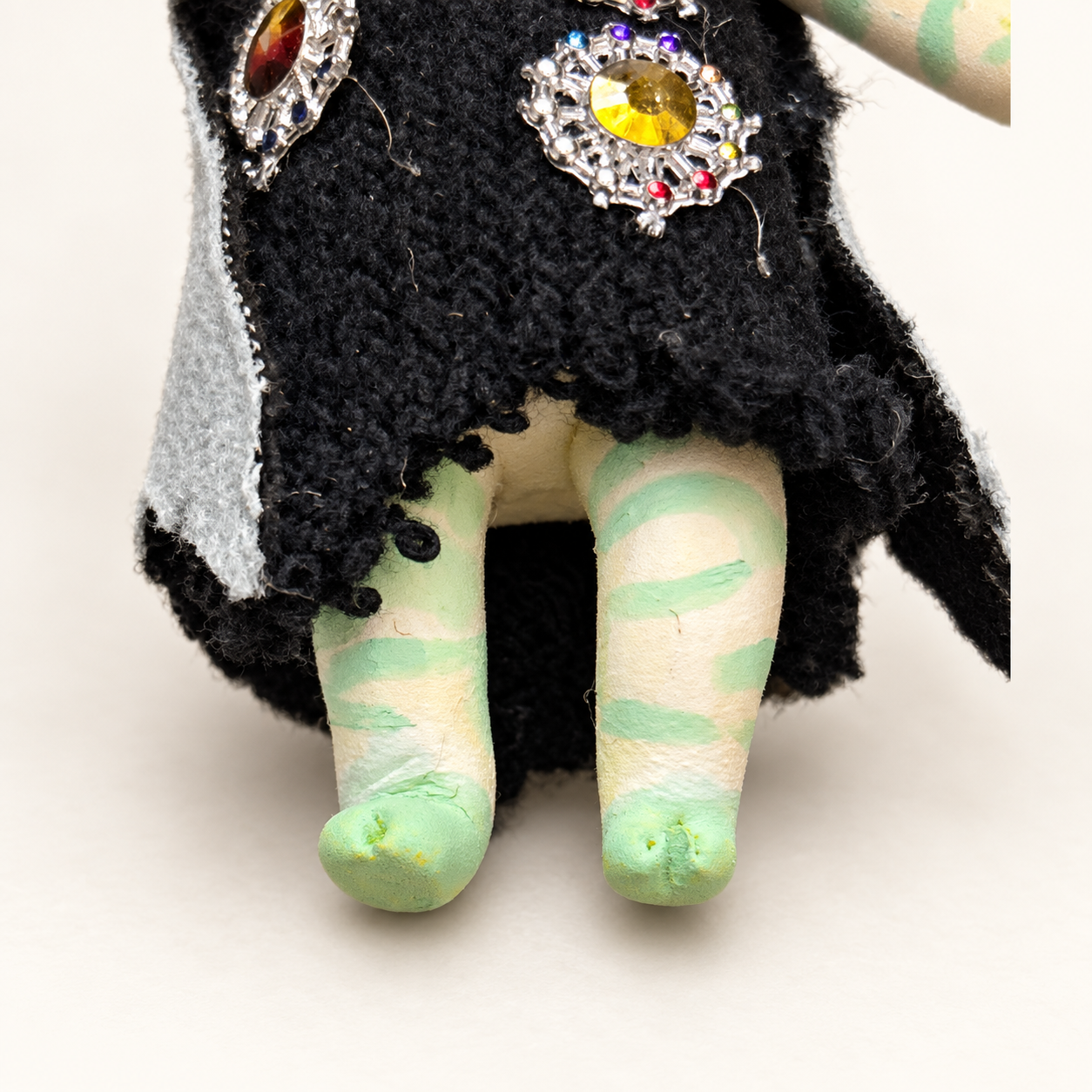 Flora, Bingo’s handmade clay character, shown from the front in a black jeweled outfit.