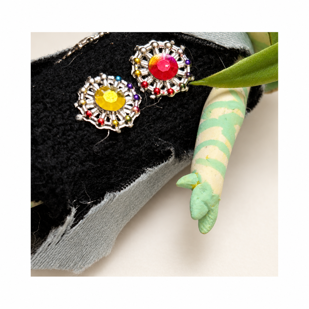 Flora, Bingo’s handmade clay character, shown from the front in a black jeweled outfit.