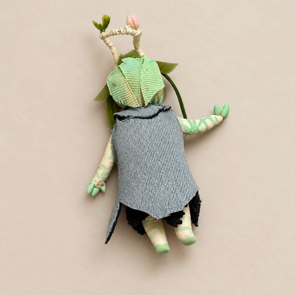 Flora, Bingo’s handmade clay character, shown from the from the back in a black jeweled outfit.