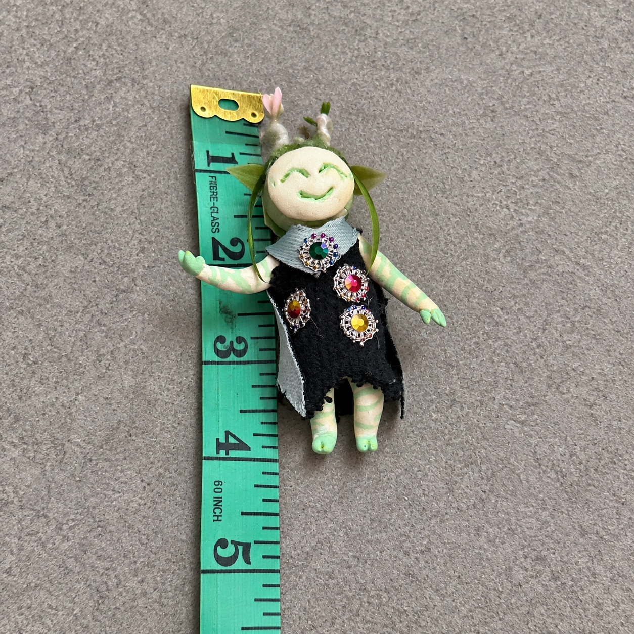 Flora, Bingo’s handmade clay character, shown from the front in a black jeweled outfit.