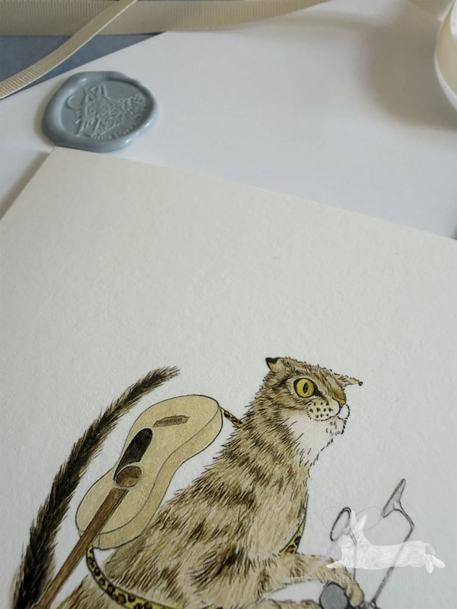 Close of a greetings card with a tabby cat on a motorbike.