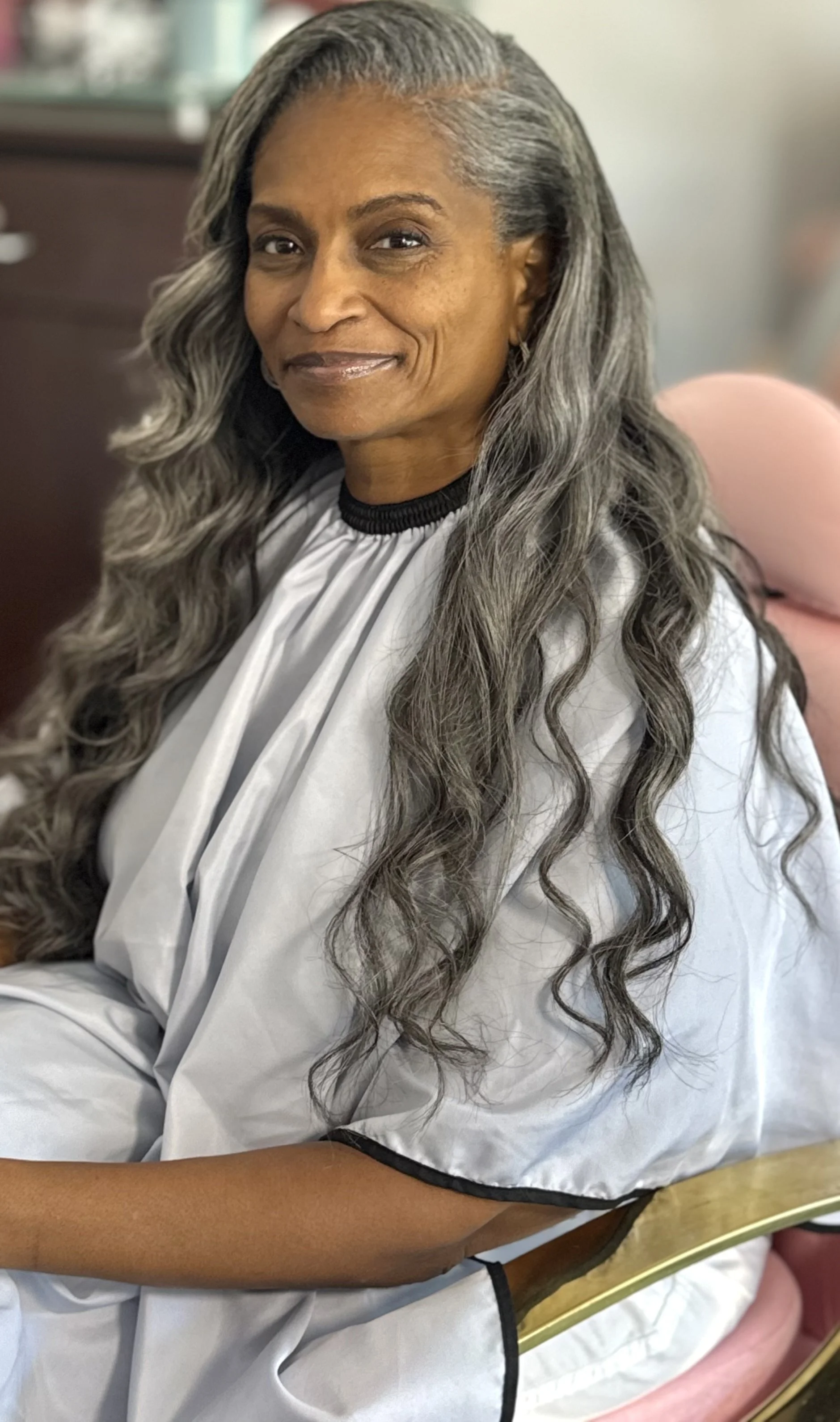 Mature woman wearing gray silver keratin bond extensions