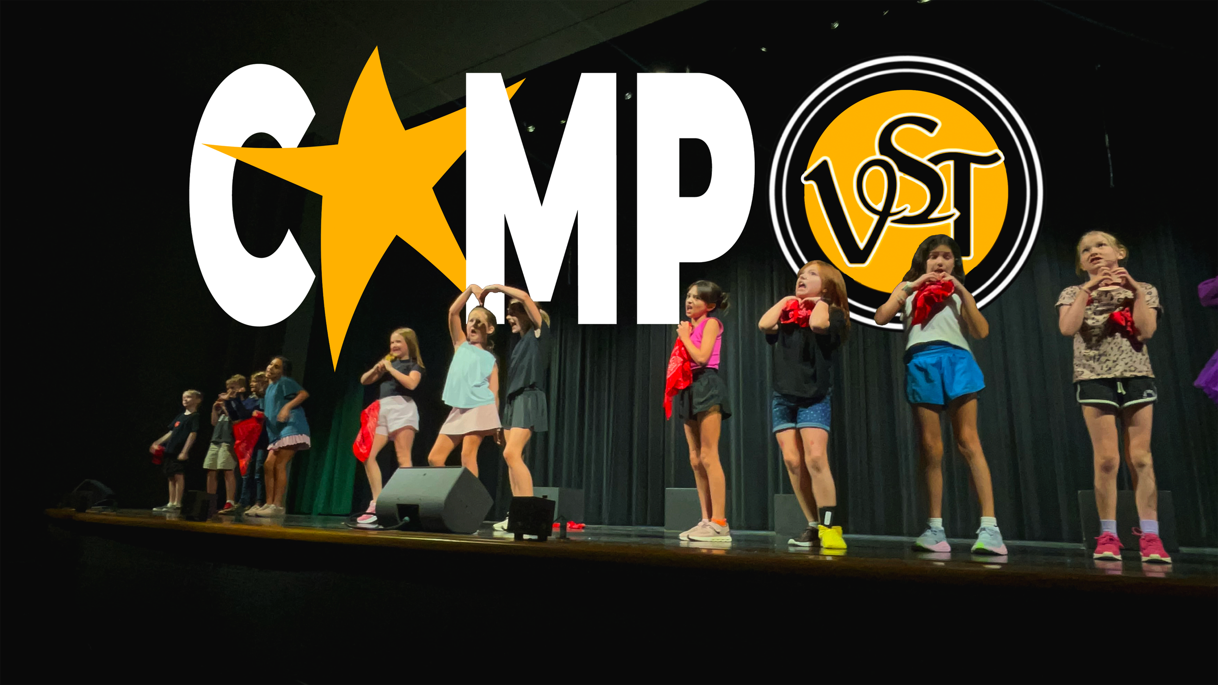 Children performing on stage during a TikTok camp event, with a large graphic and TikTok logo projected above them.