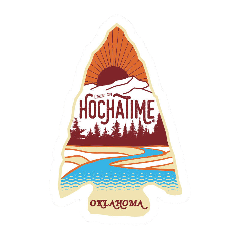 A sticker shaped like a mountain with a sunset, trees, a river, and the words "Livin' on Hochatime, Oklahoma".