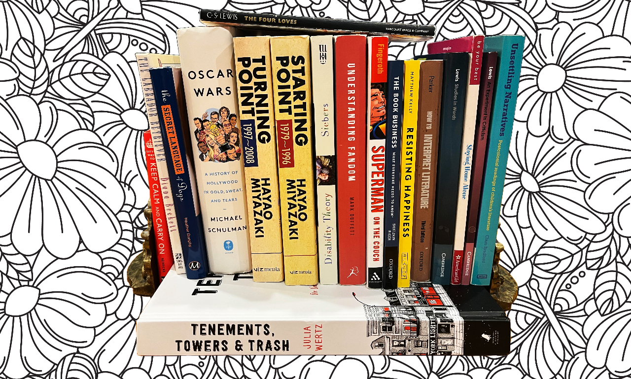 A collection of books on a decorative background with black and white floral patterns. The books are arranged vertically with titles visible, covering topics like Hollywood history, literature, and psychology.