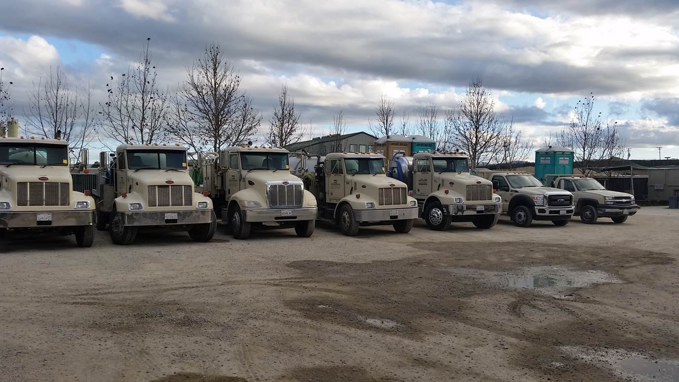 A row of trucks, a few loaded with portable restrooms, are parked just in front of the MarBorg offices in Santa Maria where they specialize in fencing and restroom services.