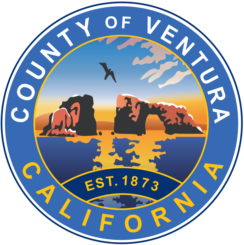 Seal of Ventura County, California showing a sunset over ocean, rocky formations, a bird flying and clouds, with the text "County of Ventura California EST. 1873" around the edge.