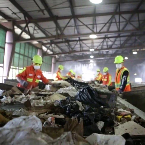 Workers sorting materials on the line at the MRF