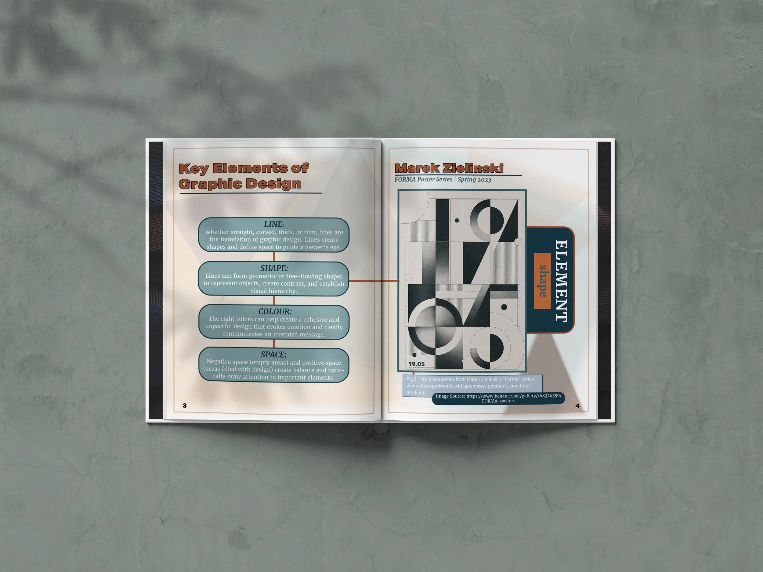 Open magazine showing an article titled 'Key Elements of Graphic Design' with detailed text and a black and white graphic illustration, placed on a greenish surface.