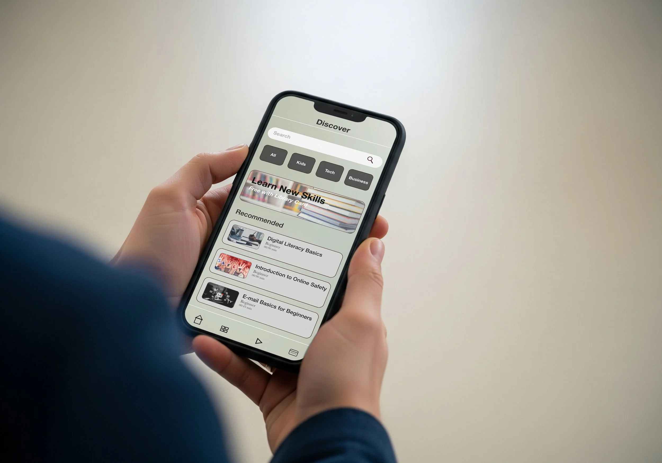A person holding a smartphone displaying a discovery section with categories such as All, Kids, Tech, and Business, and a list of recommended online courses.