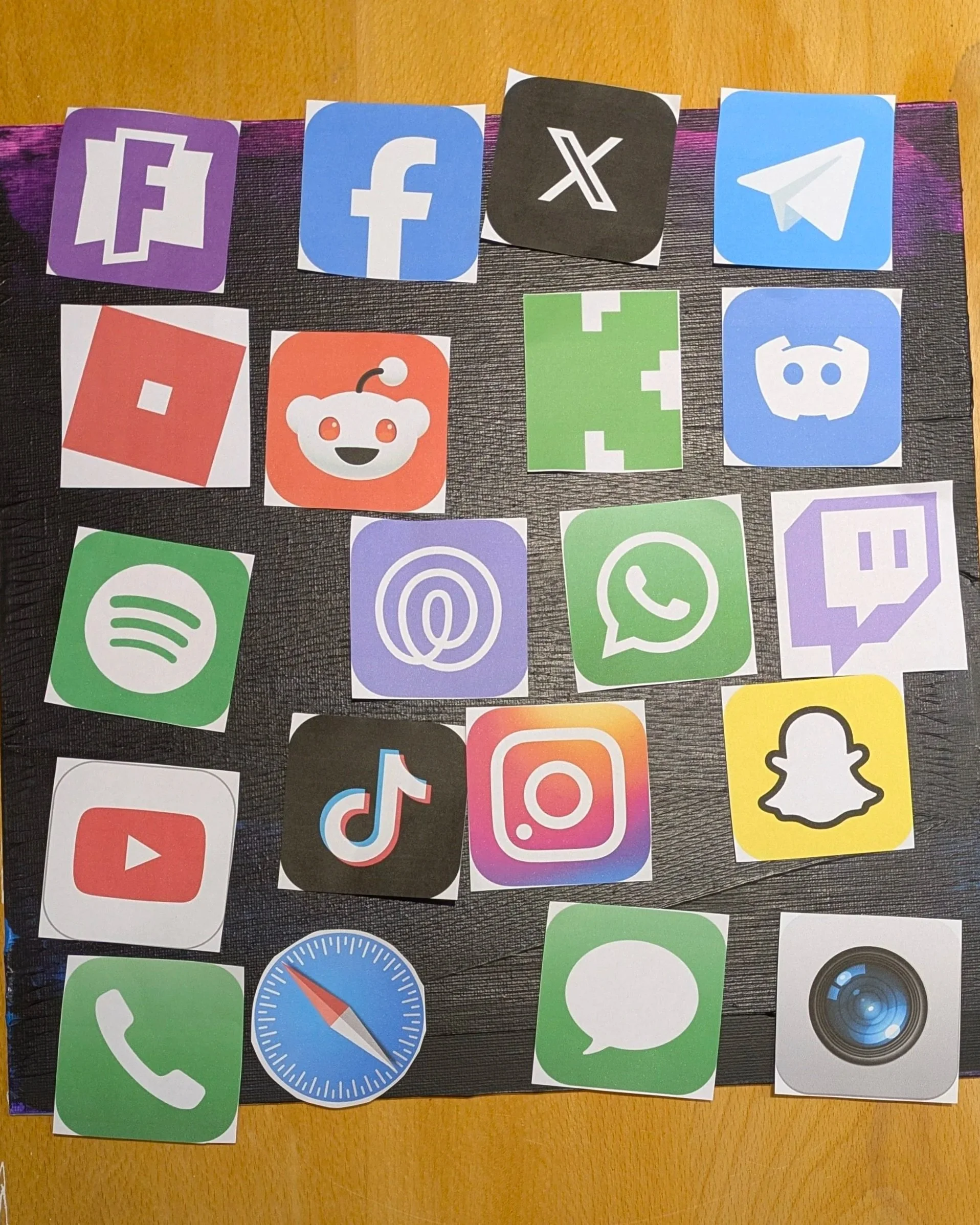 Playing with the icons on paper. First print-out, just paper, just shifting them around on the test canvas. Seeing how the colours sat together. The apps we hand our kids without thinking.