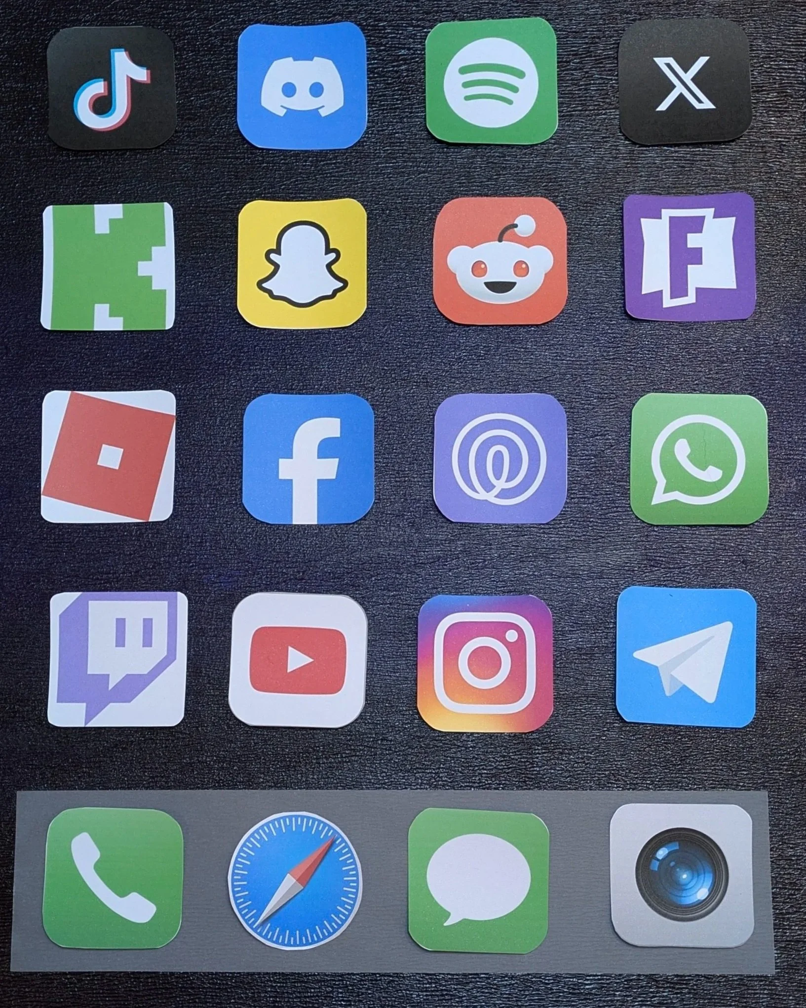 Cut and laid out. The full grid taking shape. TikTok. Snap. Discord. Life360 in the middle.