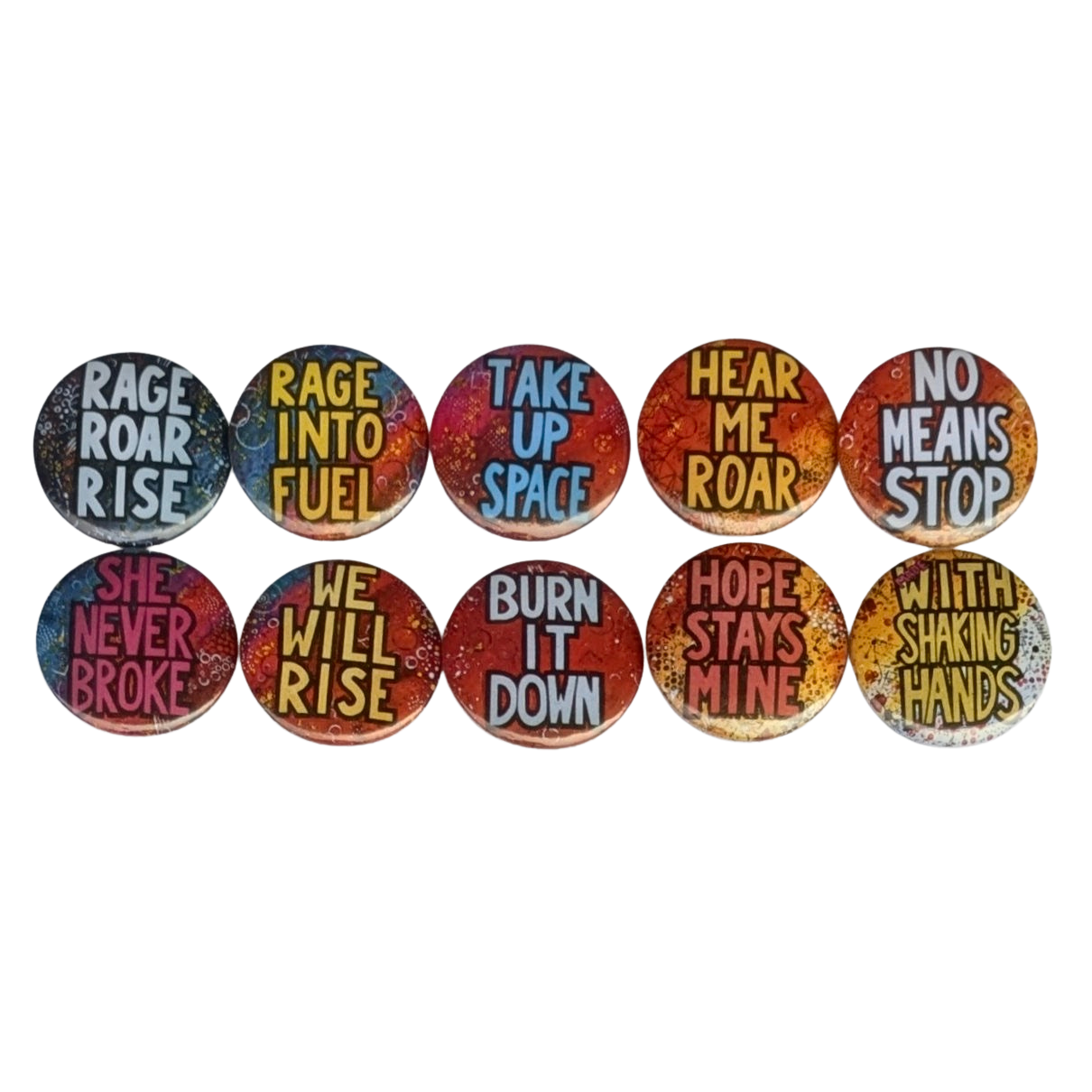 10 colourful pin badges with Unquiet slogans on