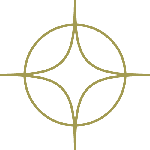 A symmetrical, abstract gold-colored geometric design with four curved lines forming a pattern within a circle.