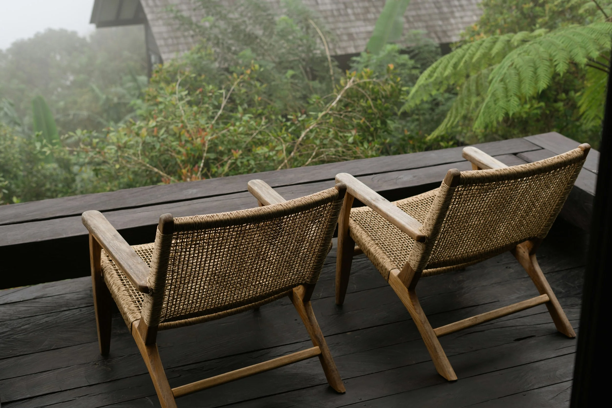 A photograph of two chairs on a deck to show an retreat-style trauma therapy intensive.