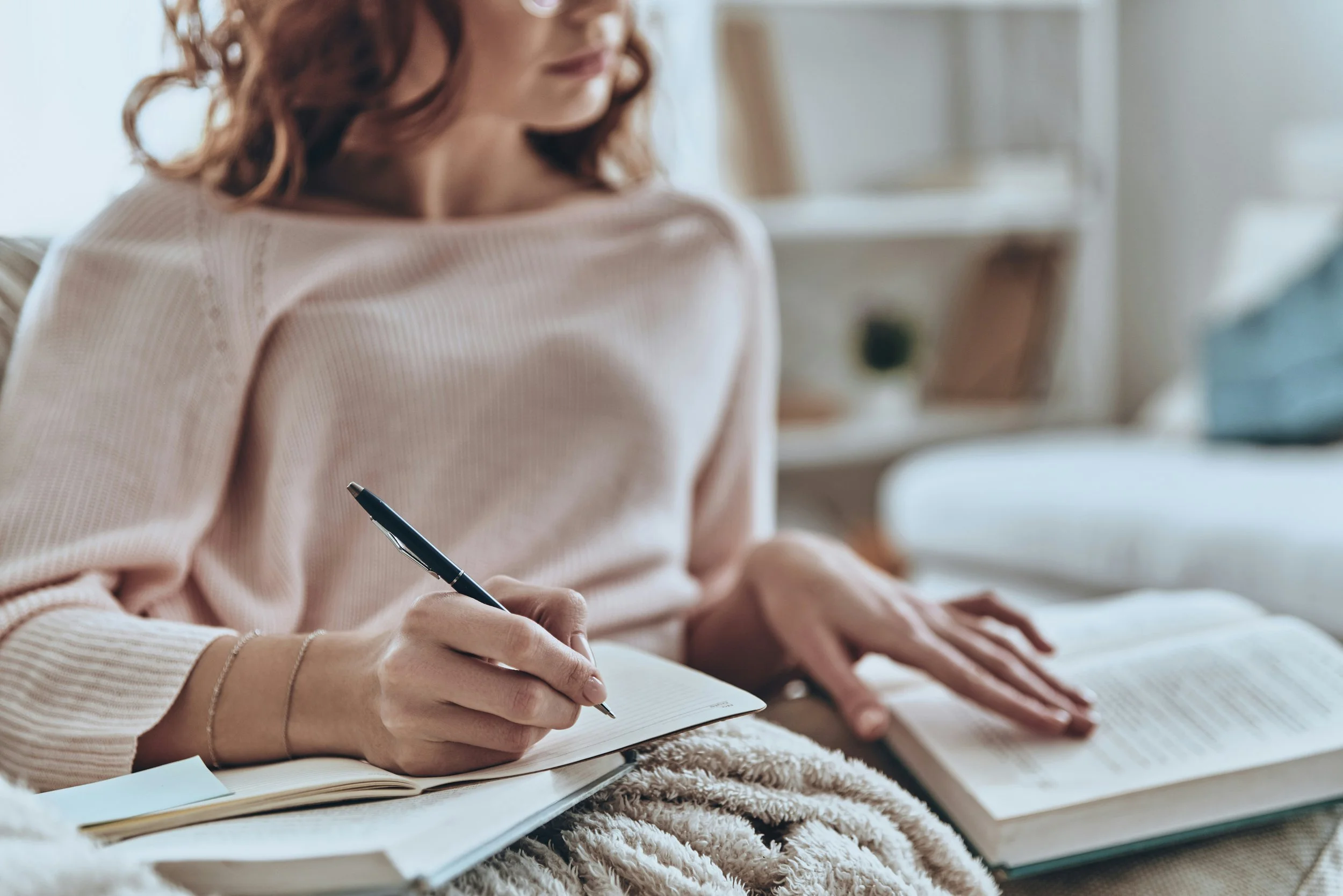A photograph of a woman journaling to illustrate that a trauma therapy intensive involves planning before and after.