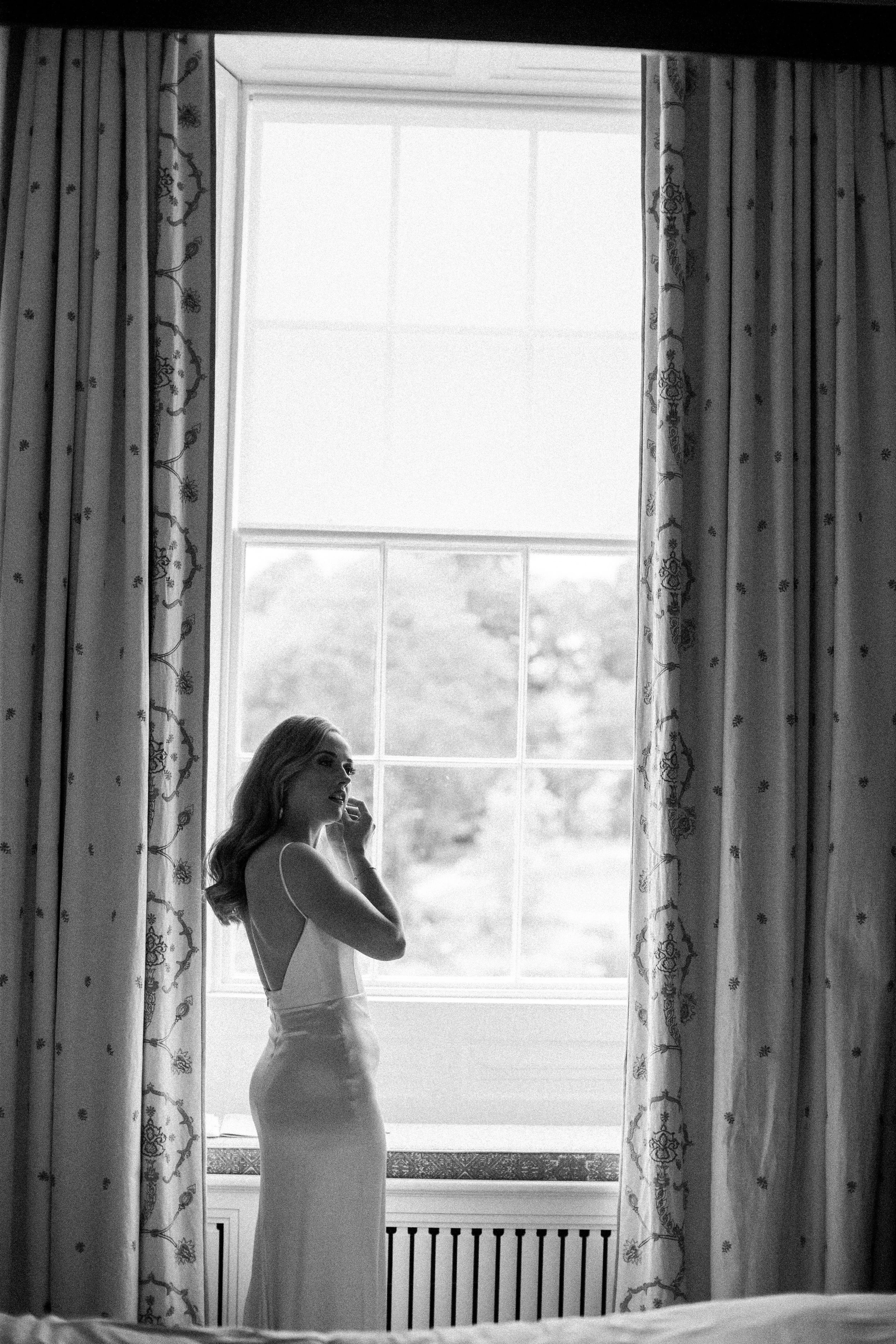 A bride standing in a window at the Cashel Palace Hotel