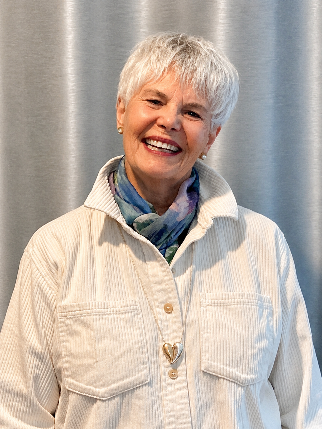 Terra smiling warmly, inviting students into a supportive space for tarot guidance, learning, and personal insight.