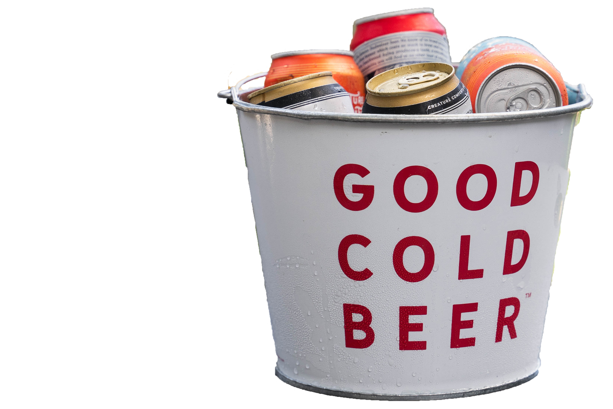 A white metal bucket labeled 'Good Cold Beer' in red text, filled with cans of various soft drinks and beer, with condensation visible on the cans.