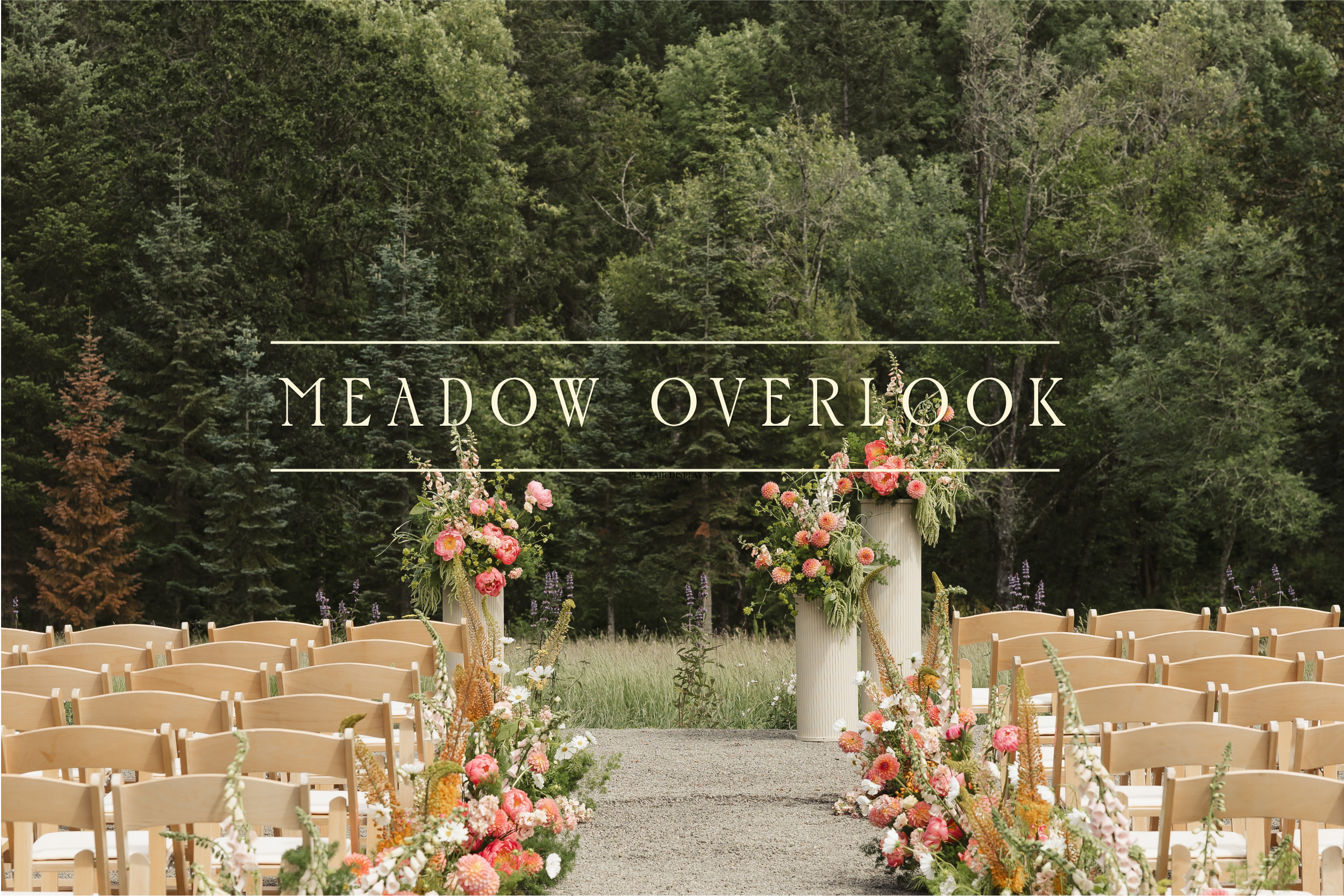 Outdoor wedding ceremony setup with rows of wooden chairs and floral arrangements, set against a backdrop of lush green trees.