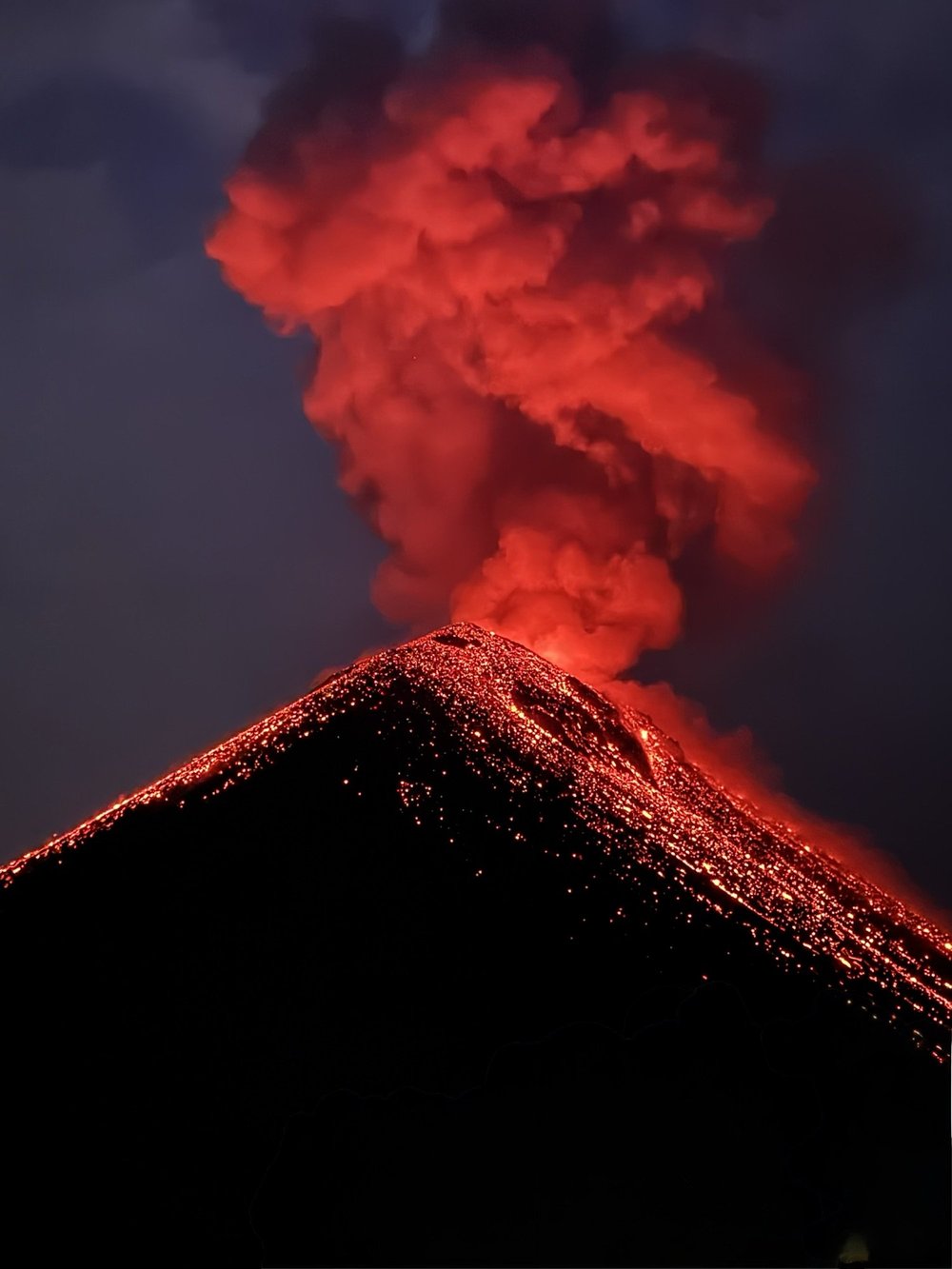 Fuego erupting at dusk from base camp