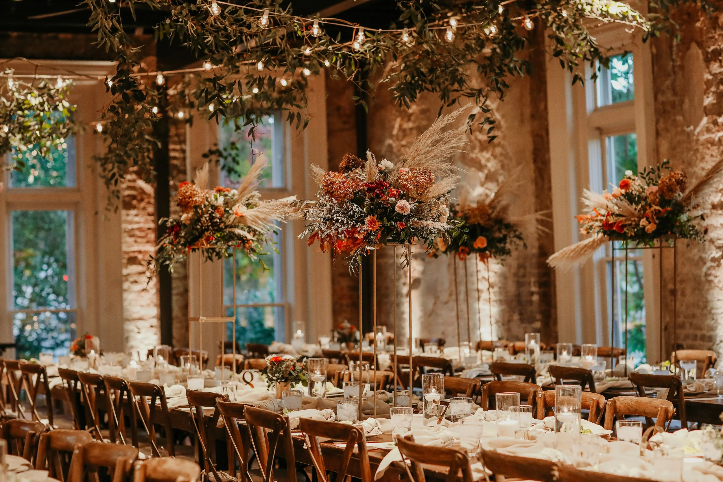 Elegant indoor event space in downtown Nashville decorated with floral arrangements and string lights, set up for a celebration or wedding reception.