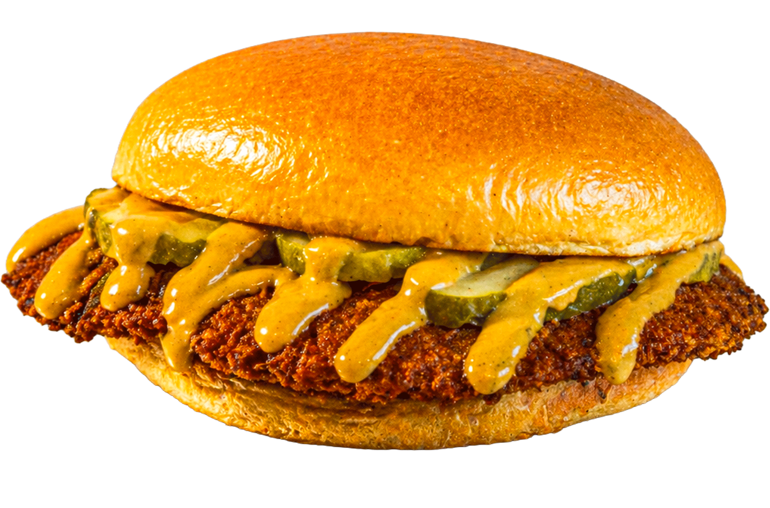 Close-up of a fried chicken sandwich with pickles, mustard, and sauce in a bun.