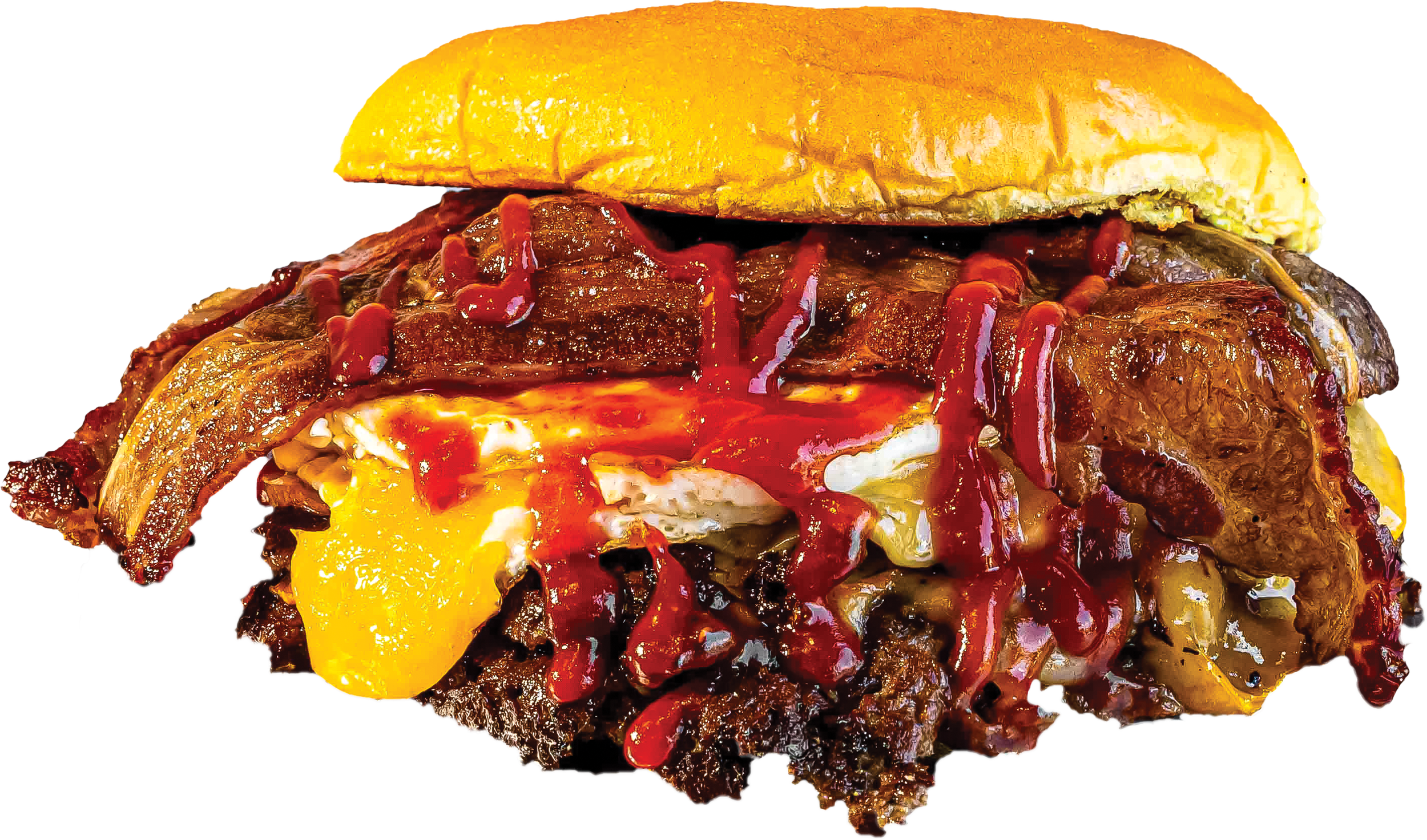 Close-up of a bacon cheeseburger with melted cheese, barbecue sauce, and a toasted bun.