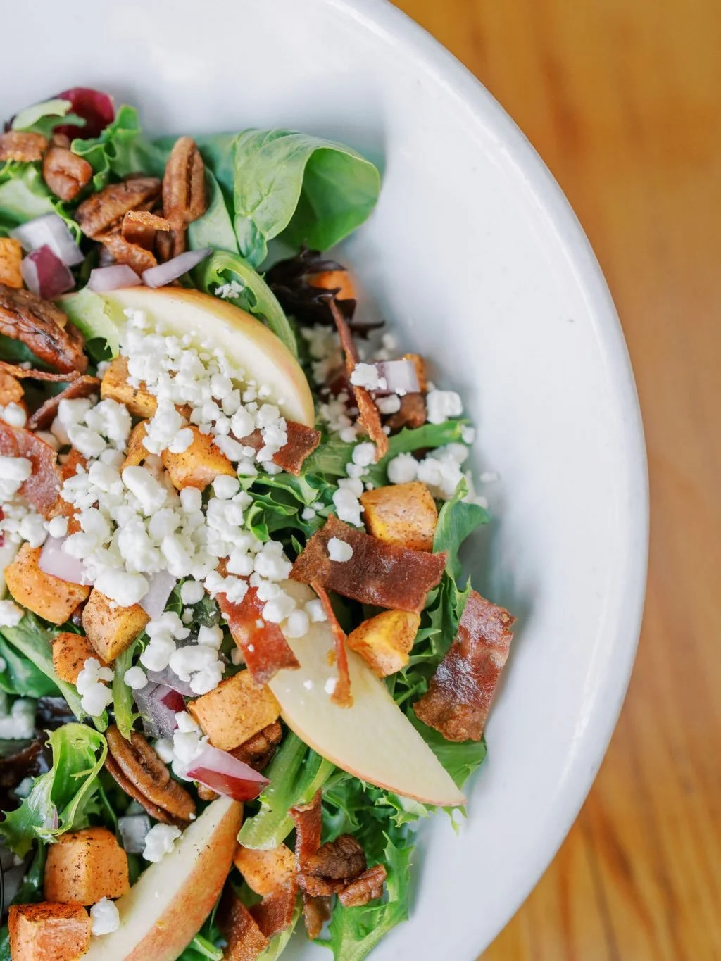 One of those salads you can&rsquo;t wait to have again:

FALL HARVEST

Cinnamon roasted sweet potato | apple slices |
pomegranate seeds | candied pecans | diced red
onion | goat cheese | balsamic vinaigrette