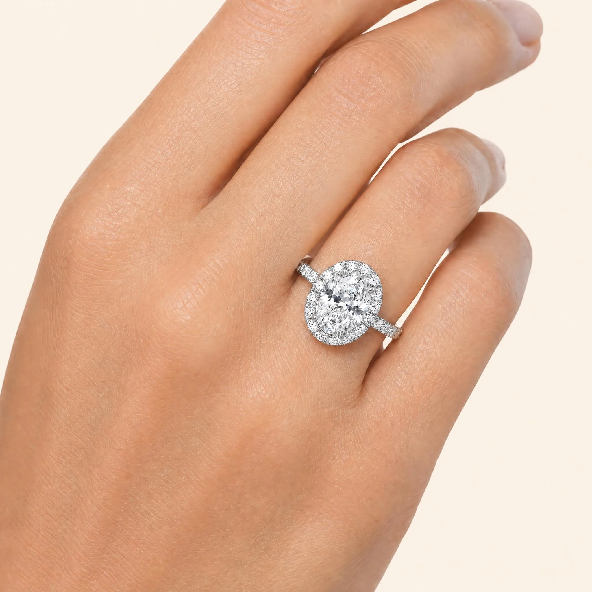 GIA-certified F VVS2 oval diamond halo engagement ring in platinum with U-pavé round brilliant diamonds.jpeg