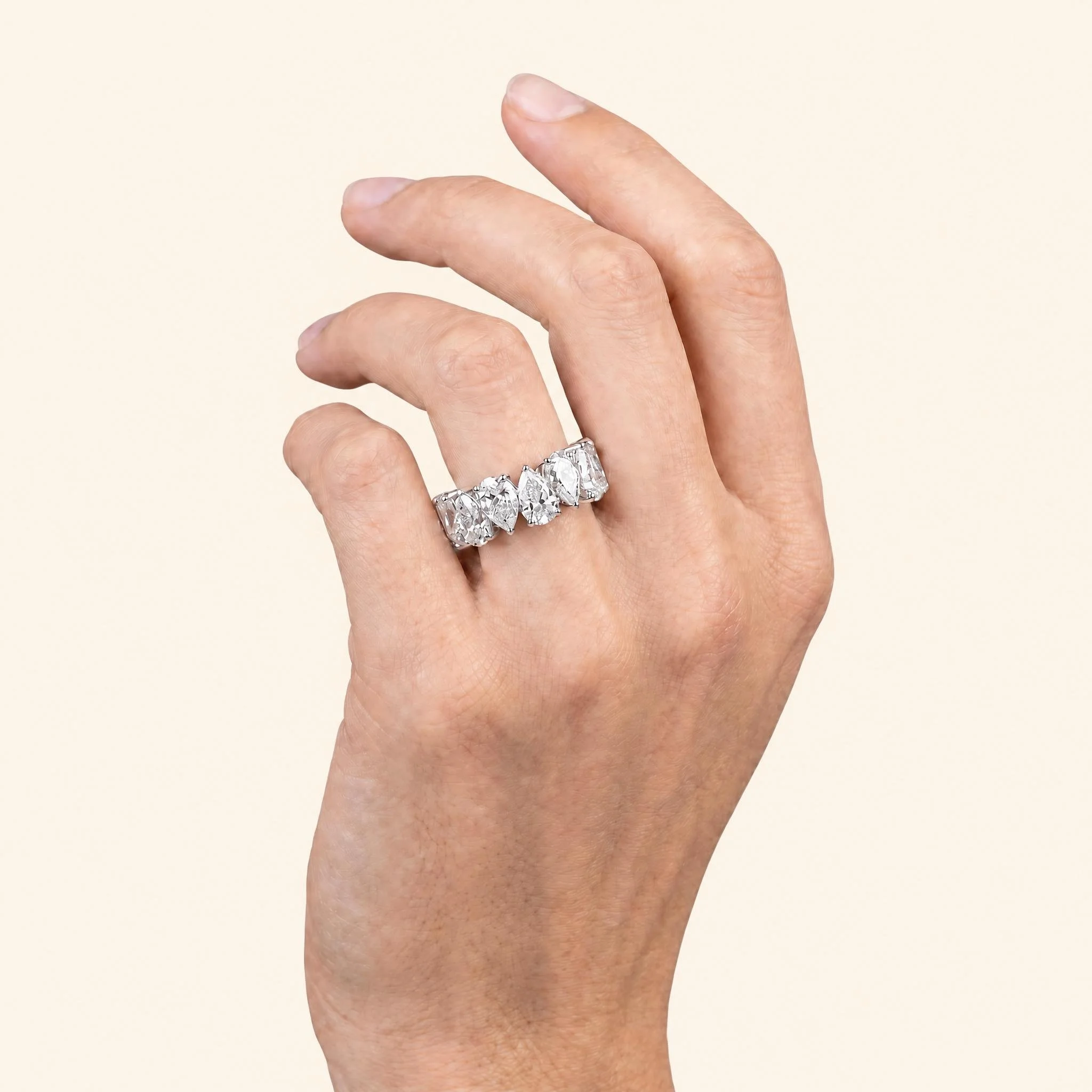 Pear diamond eternity band worn on hand.jpeg