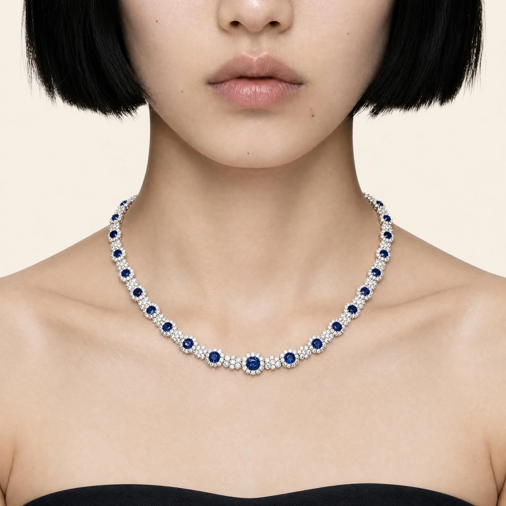 An exquisite sapphire and diamond necklace featuring richly saturated blue sapphires framed by brilliant diamond halos.jpeg