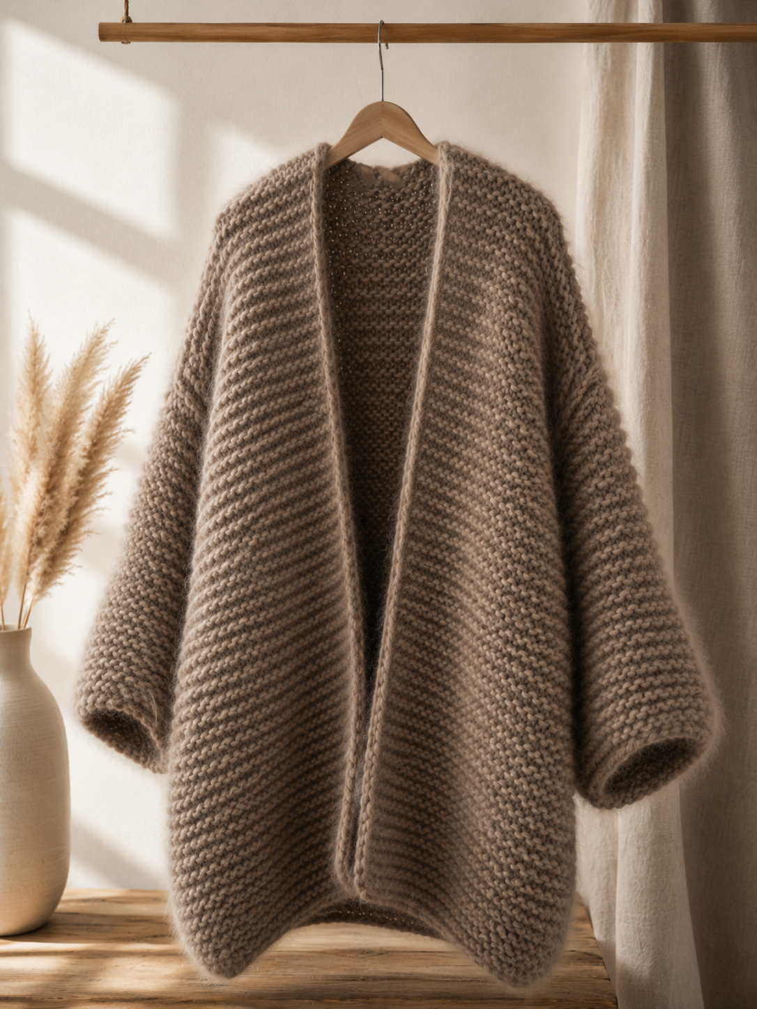 army green oversized wool chunky cardigan, long and cosy, cocoon jacket, hanging in the living room