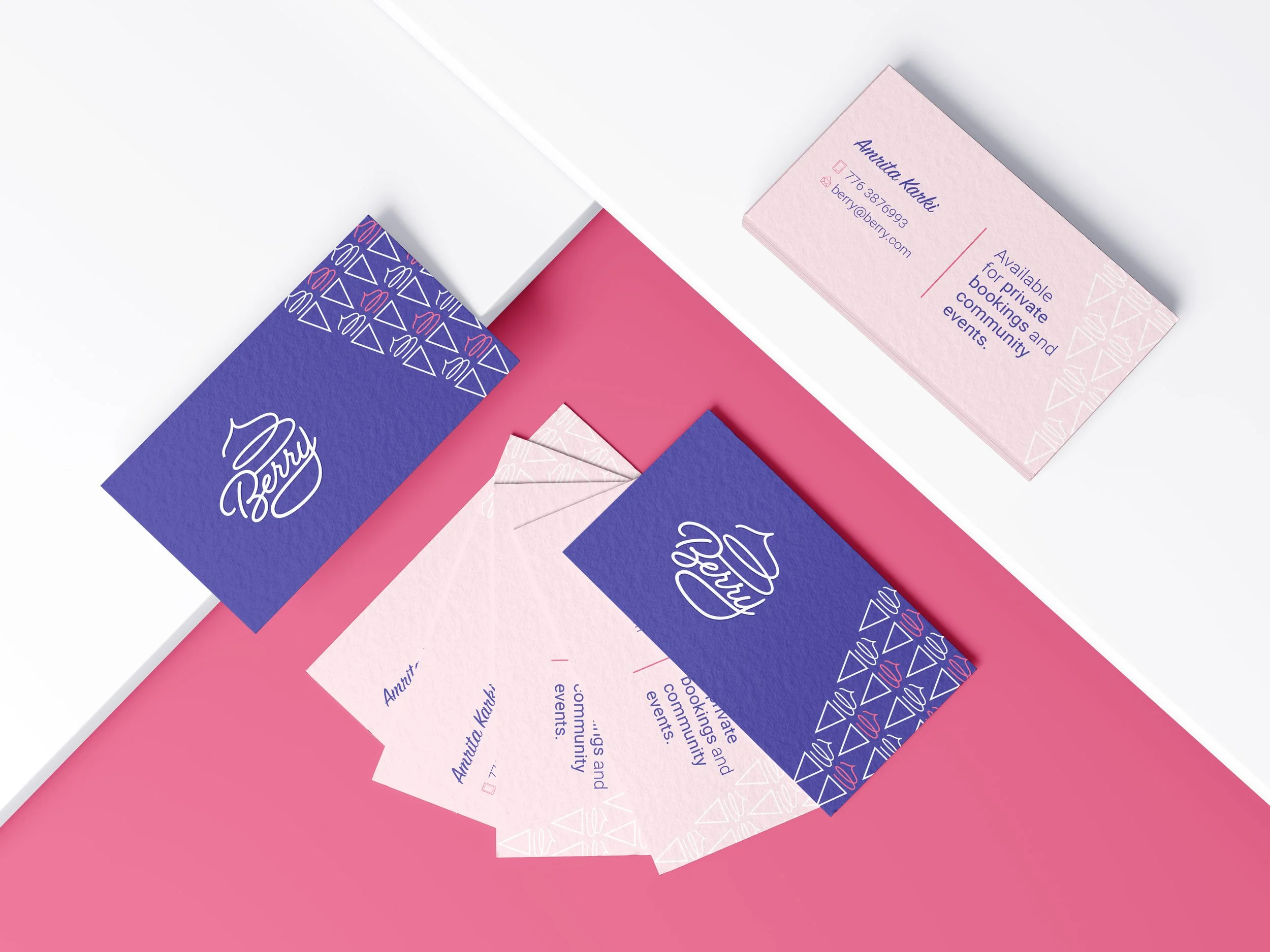 Business cards for Berry with purple and pink color schemes, featuring contact information and decorative geometric patterns, displayed on a pink and white surface.