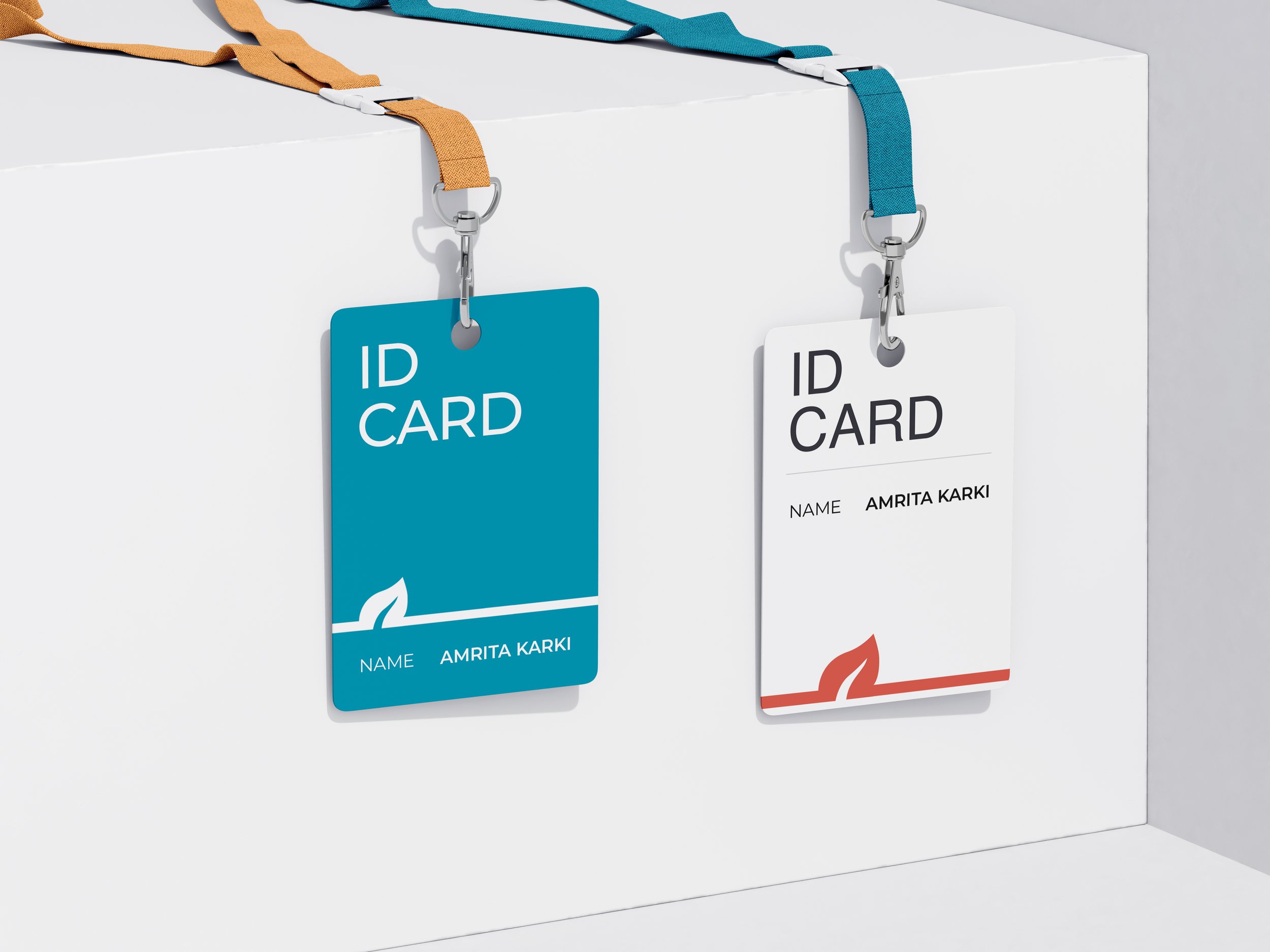 Two ID cards hanging with lanyards, one blue and one white, on a white surface.