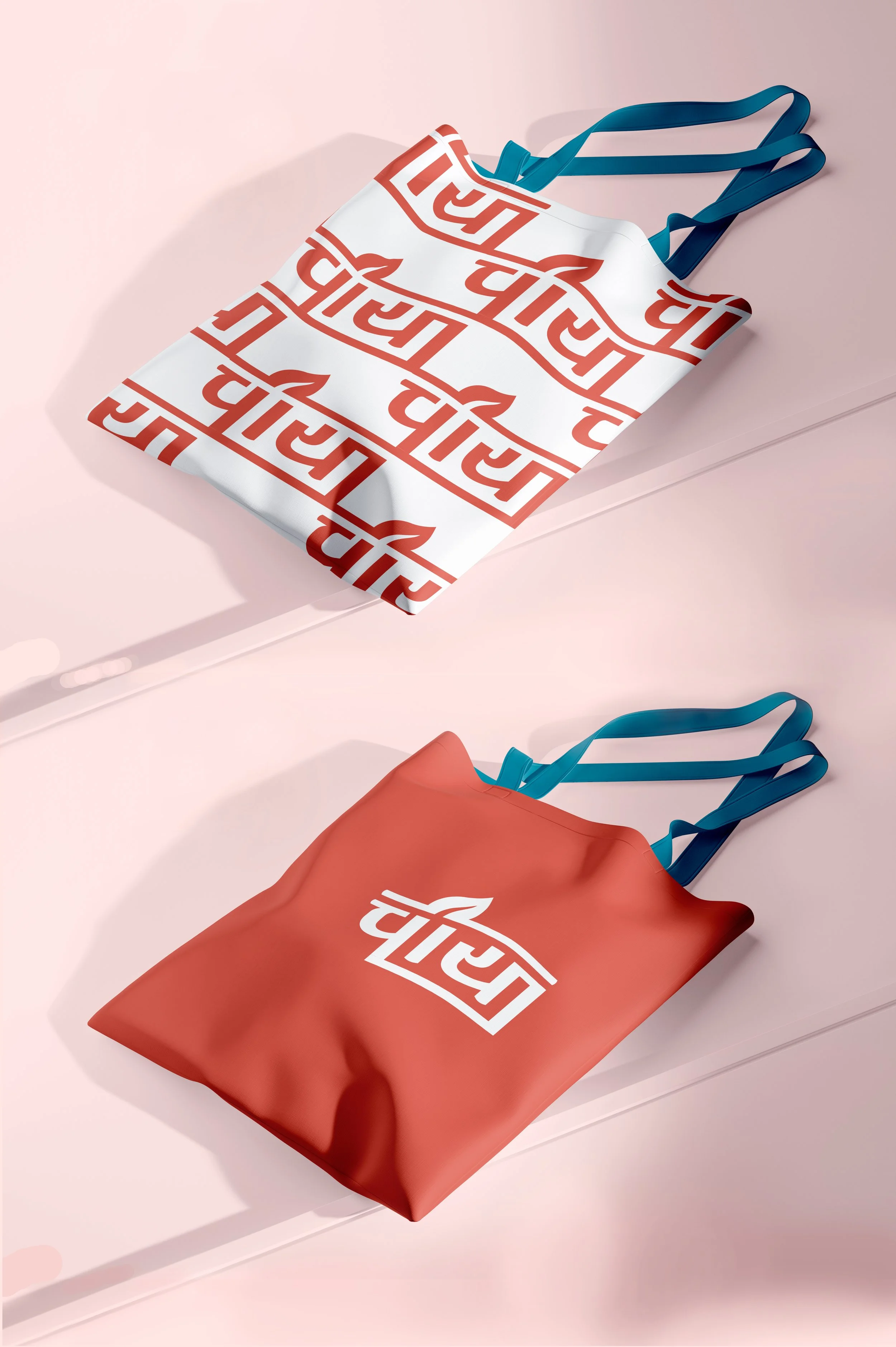 Two reusable shopping bags with the FLIPD logo, one white with red logo and one red with white logo, hanging on a light pink wall.