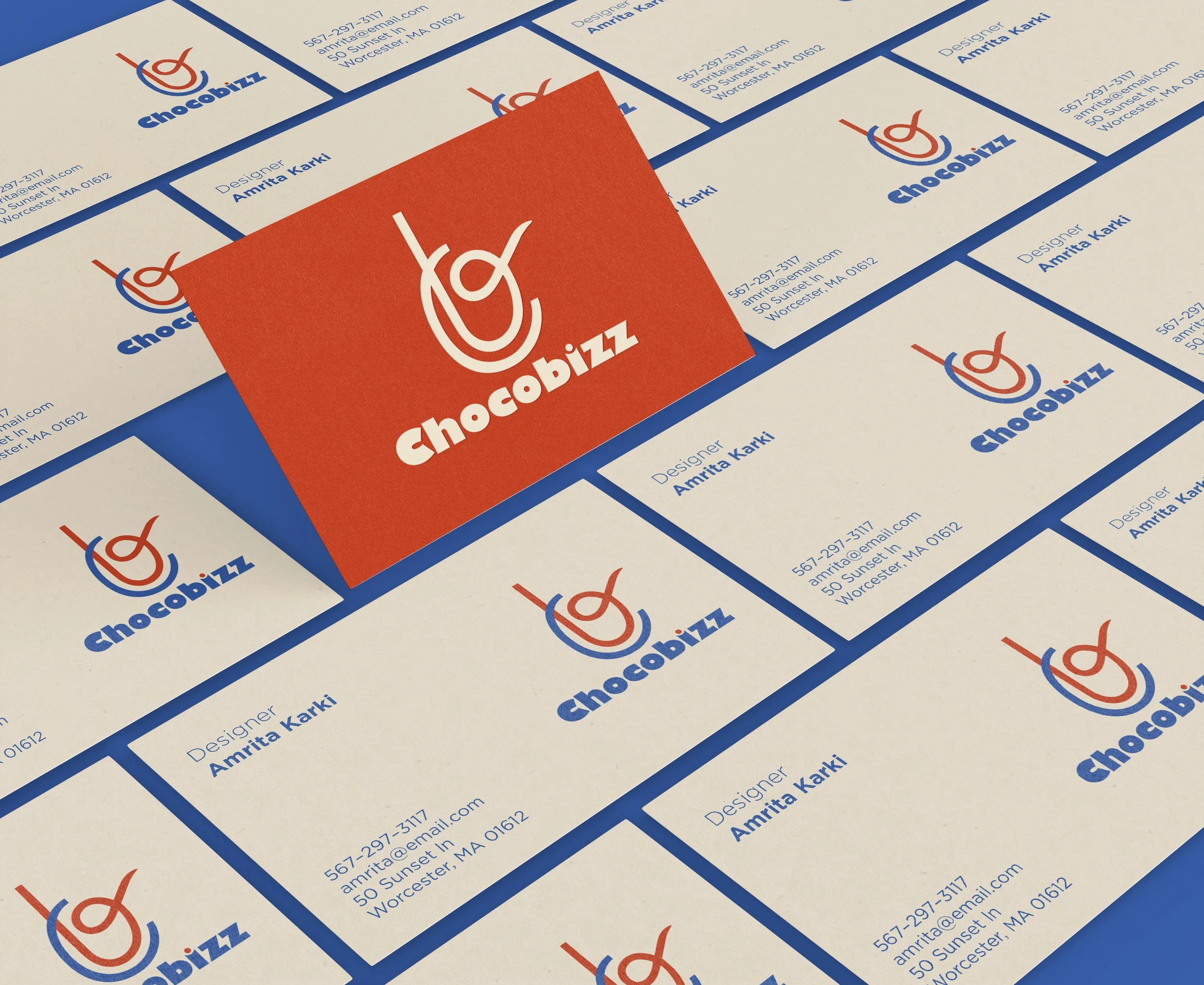 Business cards for Chocobizz with a logo featuring a stylized chocolate piece, arranged in a grid on a blue surface. The logo includes a red and blue design with the brand name in bold blue and white text. One card is center-overlapping, showing the 
