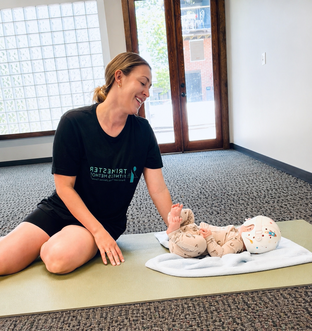 Mother and baby participating in postpartum wellness and workout class