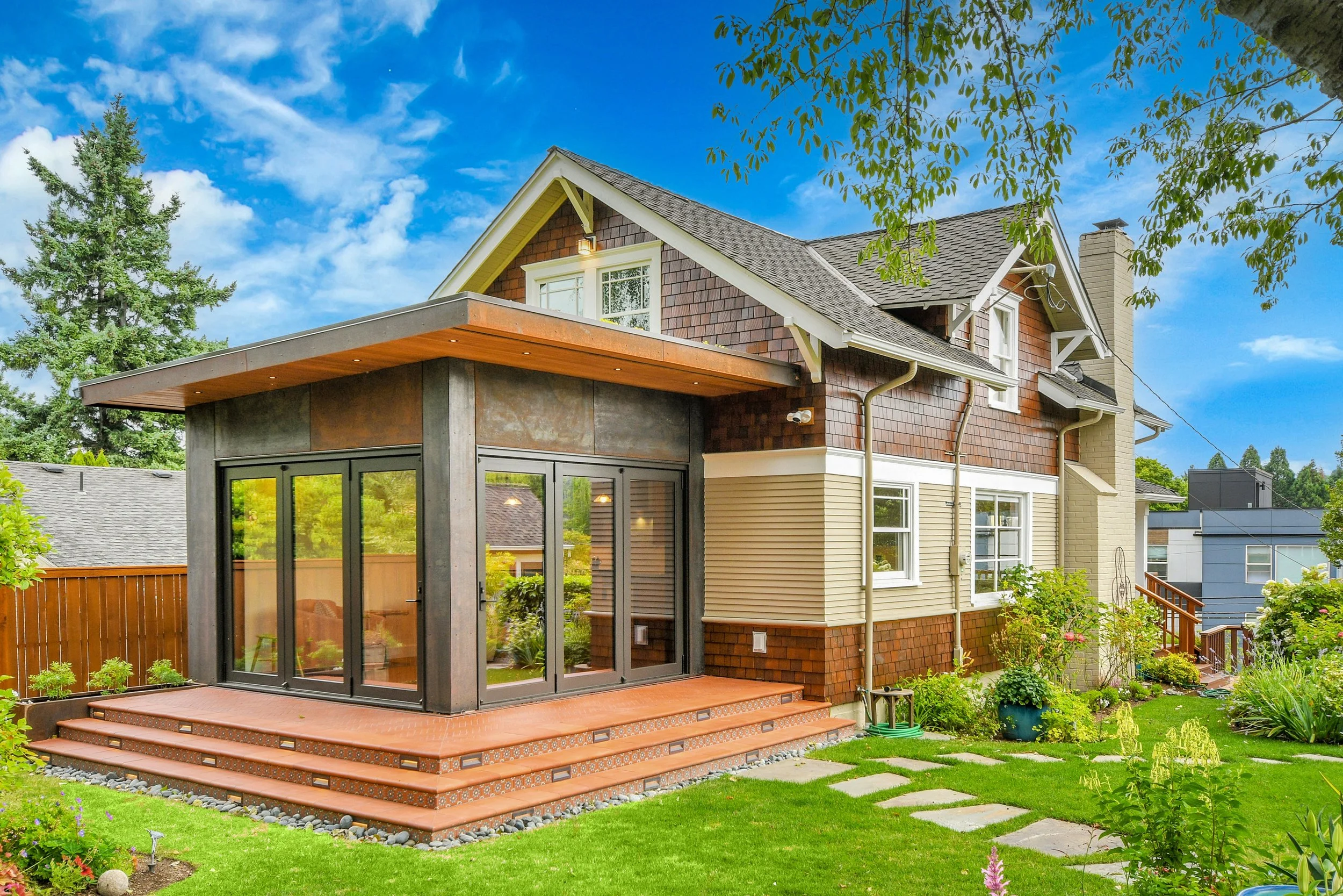 The objective of this renovation project was to create a modern nature conservatory to integrate the house with the yard and gardens, while playing off the existing craftsman structure. By incorporating bird-friendly glass in wall-to-wall accordion d