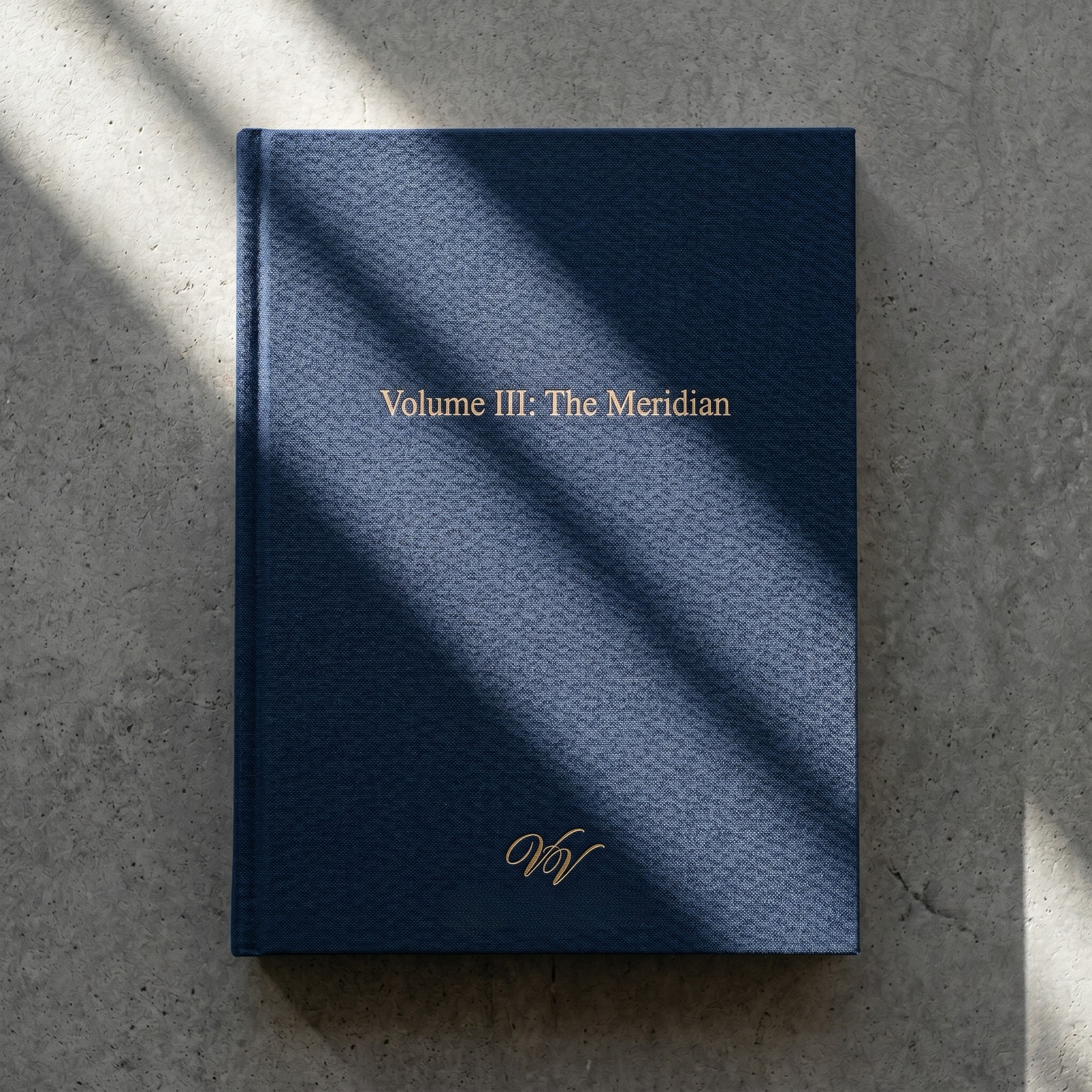 A blue hardcover book titled "Volume III: The Meridian" with gold lettering, placed on a light gray speckled surface, with shadows cast across the cover.