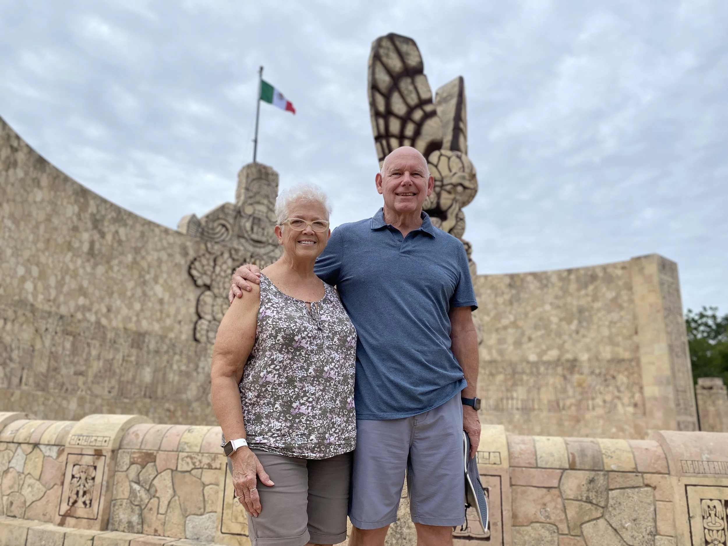 Couple standing on the north side of the Monumento a la Patria on the Paseo de Montejo in Mérida Yucatan Mexico