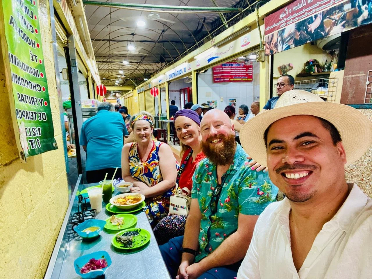 Amy Jones and Angel Rodriguez eating tacos with clients at the Garcia Rejon market in Mérida, Yucatán, Mexico.