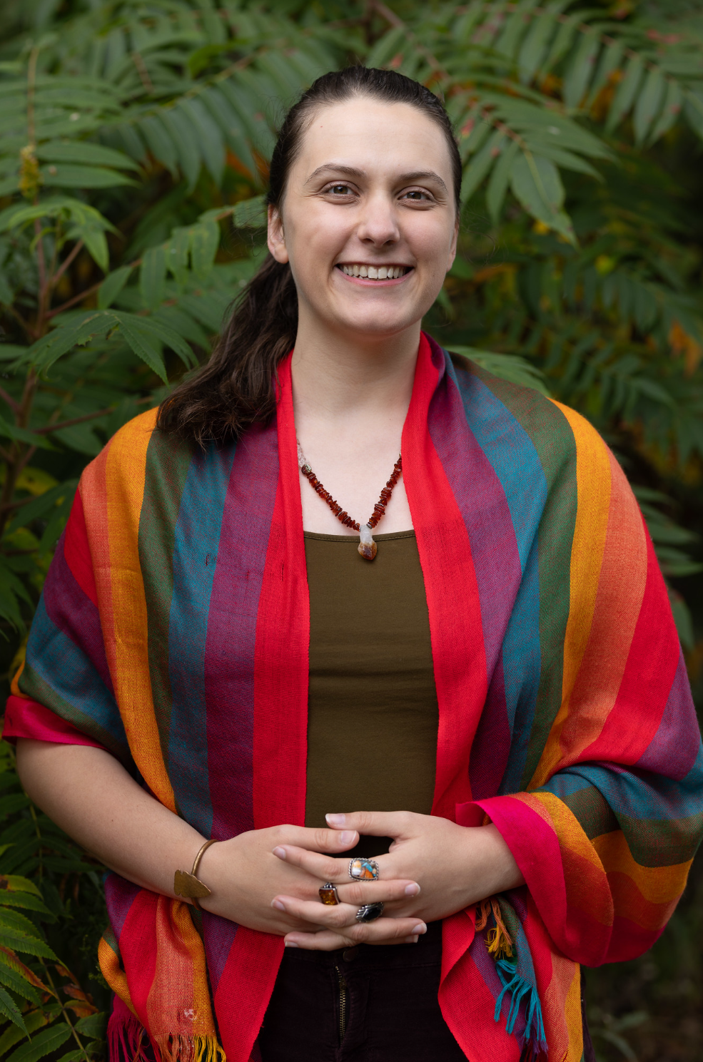 Audrey smiles in her rainbow shawl