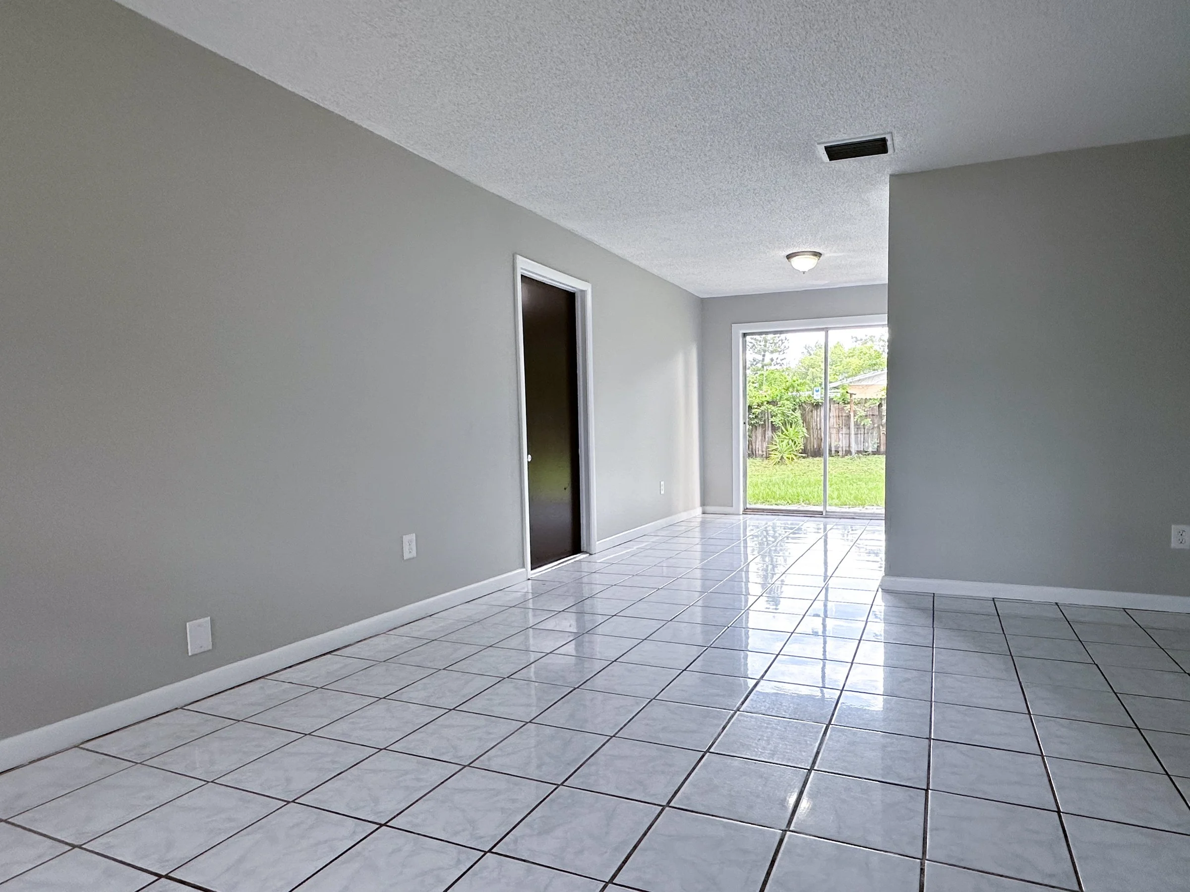 99th Ave _ House Rentals LLC _Living Room and Diningjpg.jpg