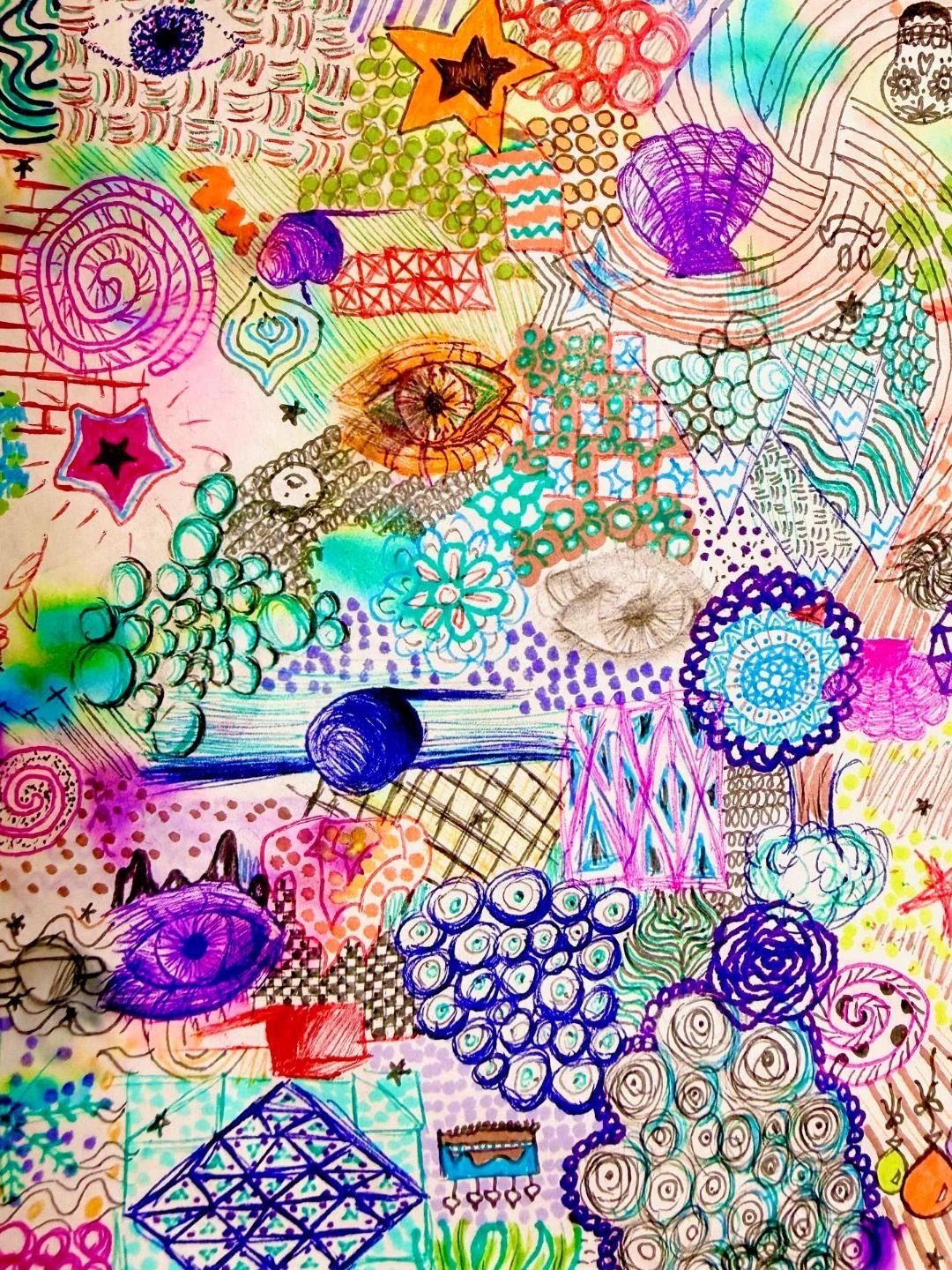 A colorful, abstract drawing filled with various doodles including eyes, stars, eyes, spirals, flowers, and geometric patterns in vibrant colors like purple, blue, green, orange, and pink.