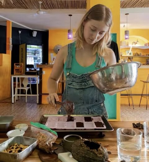 Young woman participating in a hands-on chocolate class in Puerto Viejo, Costa Rica