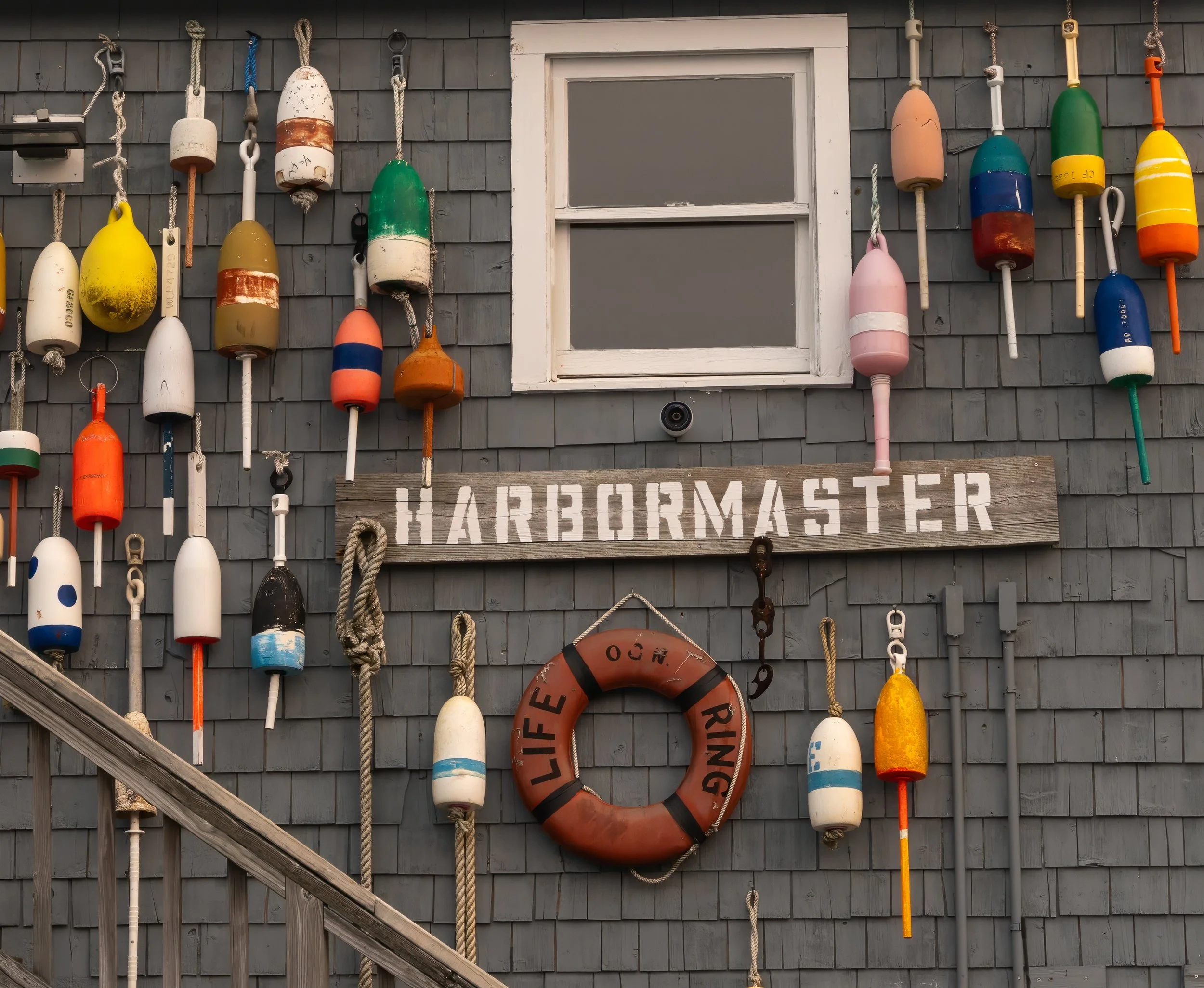 Harbormaster building decorated with colorful lobster buoys in Perkins Cove
