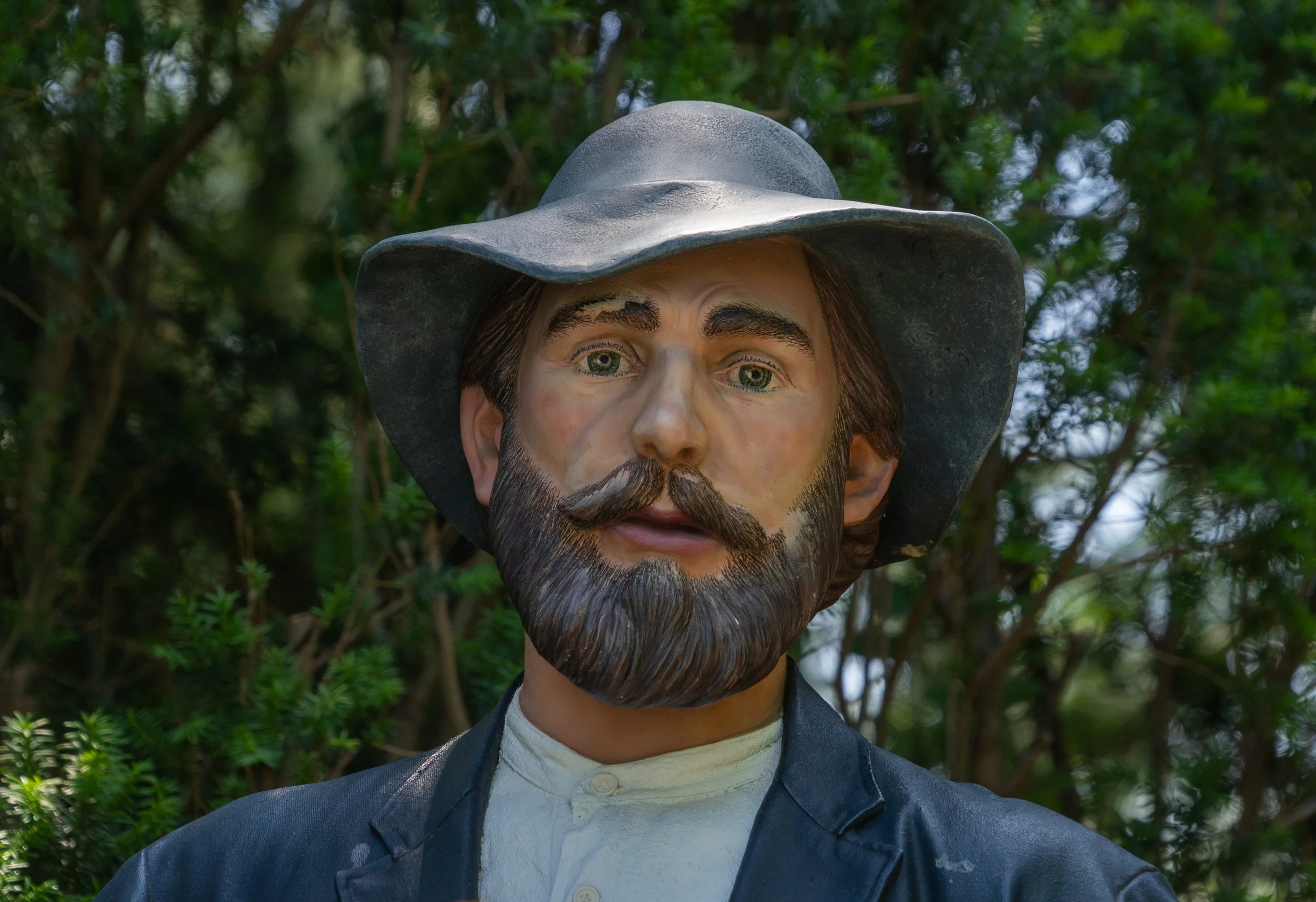 Close-up portrait of a bearded man sculpture wearing a wide-brimmed hat at Grounds For Sculpture in Hamilton, New Jersey.