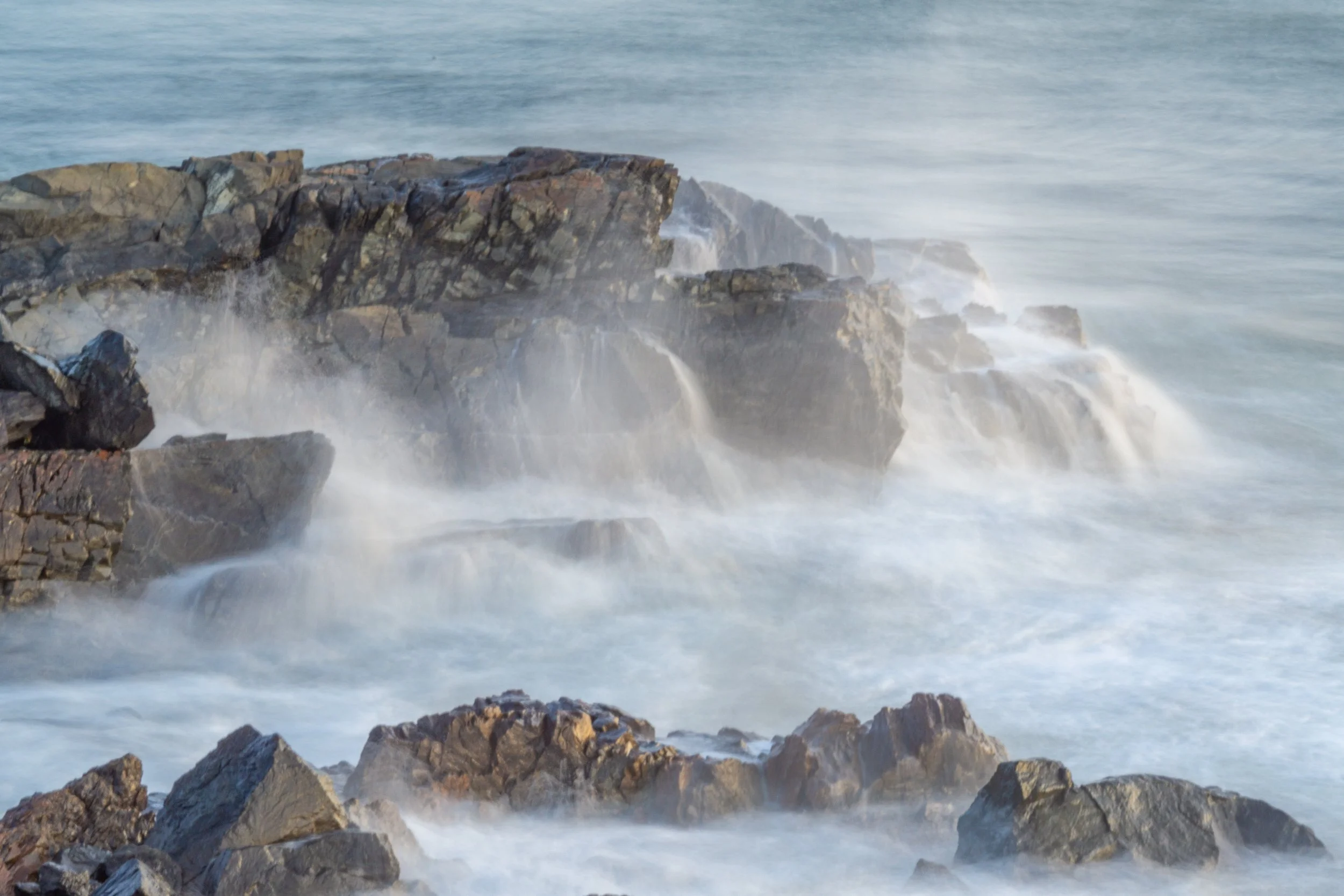 Waves breaking over rocky ledges along the Marginal Way in Ogunquit, Maine